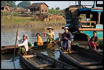 Row boats and huts on shore of Irrawaddy River. Mandalay, Myanmar ( color)