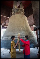 Boy and girl ringing huge bell, Mingun. Myanmar ( color)