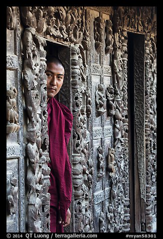 Monk pearing from window, Shwe In Bin Kyaung pagoda. Mandalay, Myanmar (color)
