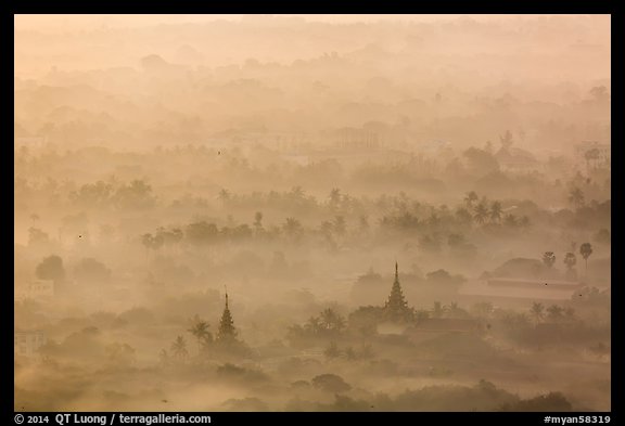 Pagodas and tree ridges in mist as seen from Mandalay Hill. Mandalay, Myanmar