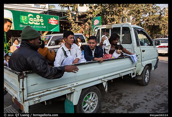 Families riding on back of pick-up truck. Mandalay, Myanmar (color)