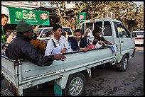 Families riding on back of pick-up truck. Mandalay, Myanmar ( color)