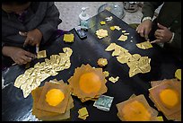Gossamer-thin pieces of gold cut in squares, gold leaf workshop. Mandalay, Myanmar ( color)