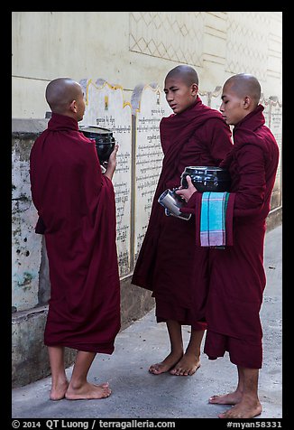 Three monks conversing at Mahagandayon Monastery. Amarapura, Myanmar (color)