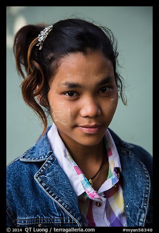 Woman with blue jeans jacket and thanaka paste. Mandalay, Myanmar (color)
