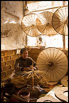 Woman assembling the paper umbrellas carried by the monks. Pindaya, Myanmar ( color)