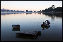 Woman washing laundry in Pone Tanoke Lake at dawn. Pindaya, Myanmar ( color)