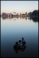 Woman washing laundry in Pone Tanoke Lake at sunrise. Pindaya, Myanmar ( color)