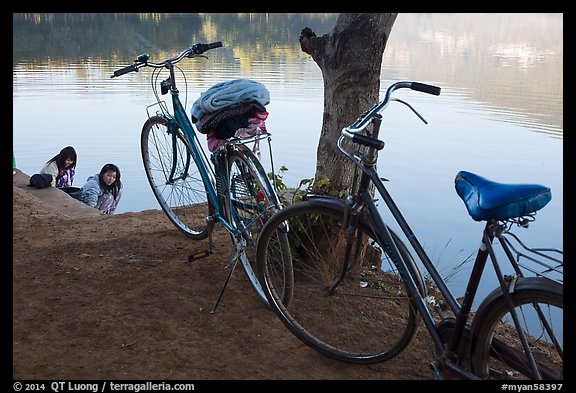 Bicycles and women doing laundry in Pone Tanoke Lake. Pindaya, Myanmar (color)