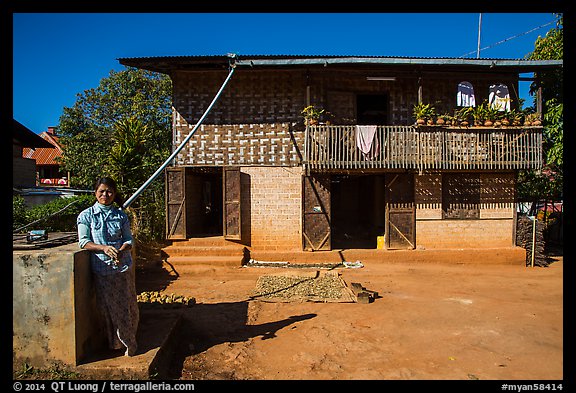 Woman in front of house. Pindaya, Myanmar (color)