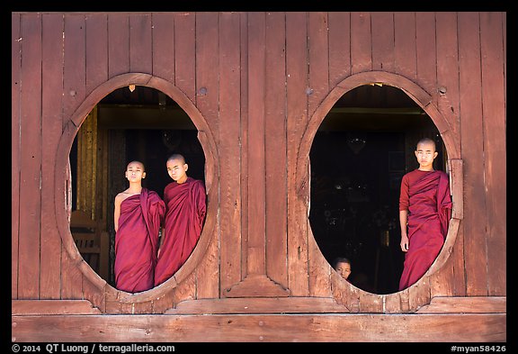 Monks standing in oval windows, Shweyanpyay Monastery, Nyaung Shwe. Inle Lake, Myanmar (color)