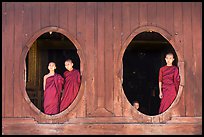 Monks standing in oval windows, Shweyanpyay Monastery, Nyaung Shwe. Inle Lake, Myanmar ( color)