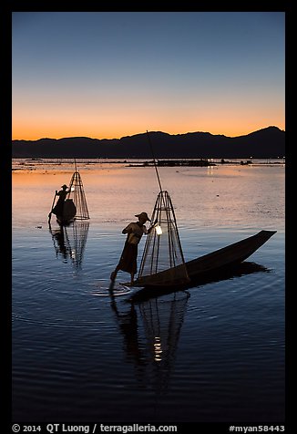Intha fishermen carrying lanterns at dusk. Inle Lake, Myanmar (color)