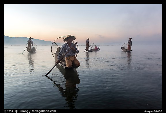 Group of Intha fishermen at dawn with surface mist. Inle Lake, Myanmar (color)