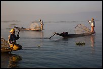 Intha fishermen rowing boats in early morning mist. Inle Lake, Myanmar ( color)