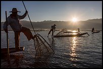Intha fisherman using spear sticking through the top of basket to expose fish. Inle Lake, Myanmar ( color)
