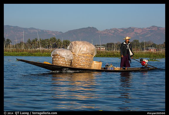 Man transporting baskets on boat. Inle Lake, Myanmar (color)
