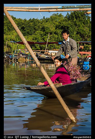 Couple leaving market on their boat. Inle Lake, Myanmar (color)