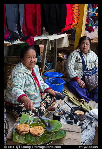 Woman cooking burmese pancakes at market. Inle Lake, Myanmar (color)