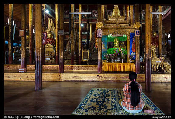 Woman praying at Nga Phe Kyaung monastery. Inle Lake, Myanmar (color)