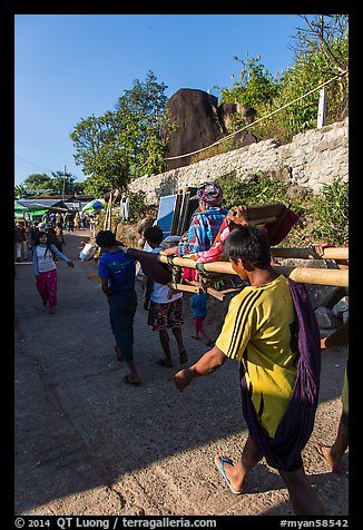 Vistor carried by porters on sedan chair,. Kyaiktiyo, Myanmar (color)