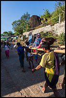 Vistor carried by porters on sedan chair,. Kyaiktiyo, Myanmar ( color)