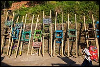 Child walking past sedan chairs. Kyaiktiyo, Myanmar ( color)