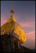 Monk standing on Golden Rock looks into the valley. Kyaiktiyo, Myanmar ( color)