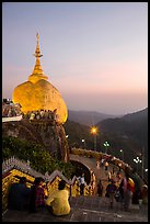 Pilgrims look at the Golden Rock from lower platform at sunset. Kyaiktiyo, Myanmar ( color)