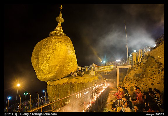 Pilgrims pray next to the Golden Rock. Kyaiktiyo, Myanmar (color)