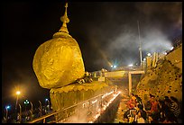 Pilgrims pray next to the Golden Rock. Kyaiktiyo, Myanmar ( color)