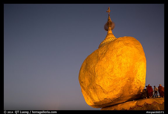 Golden Rock balancing boulder stupa and monks at dawn. Kyaiktiyo, Myanmar (color)