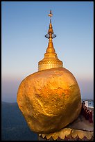 Monks standing in prayer near the Golden rock at sunrise. Kyaiktiyo, Myanmar ( color)