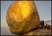 Monks praying at the Golden Rock balancing boulder. Kyaiktiyo, Myanmar ( color)