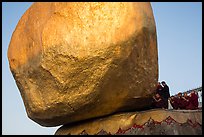 Monks kneeling in prayer at the Golden Rock. Kyaiktiyo, Myanmar ( color)