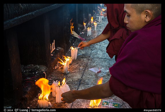 Monks lighting candles. Kyaiktiyo, Myanmar (color)