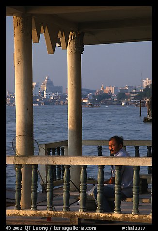 Man fishing on the Chao Phraya river. Bangkok, Thailand