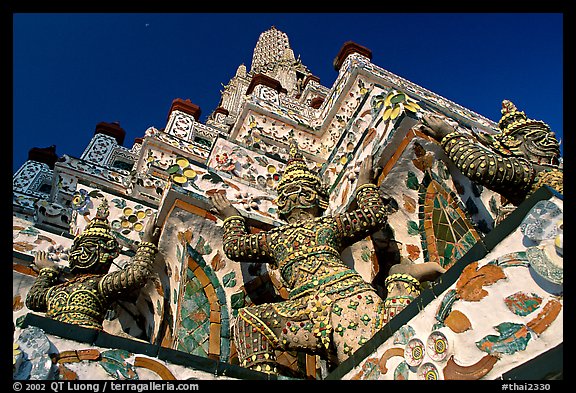 Statues at the base of the prang, Wat Arun. Bangkok, Thailand