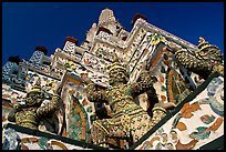 Statues at the base of the prang, Wat Arun. Bangkok, Thailand ( color)