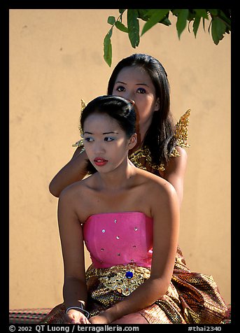 Mother helps daughter with traditional thai attire, Wat Arun. Bangkok, Thailand (color)