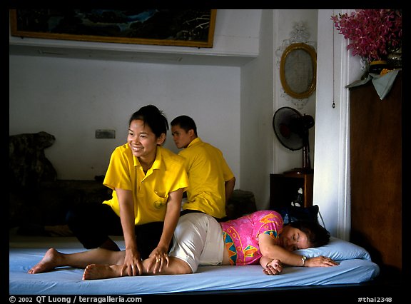 Traditional thai massage in traditional Thai medicine center of Wat Pho. Bangkok, Thailand (color)