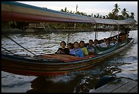 Evening commute, long tail taxi boat on canal. Bangkok, Thailand