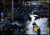 Woman paddling, floating market. Damnoen Saduak, Thailand