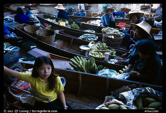 Woman on small boat, floating market. Damnoen Saduak, Thailand (color)