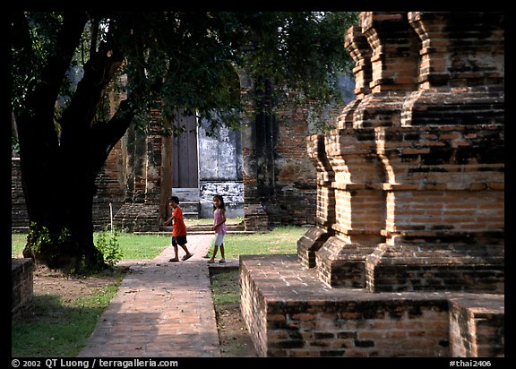 Children walk among ruins of the King Narai's palace. Lopburi, Thailand (color)