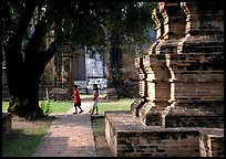 Children walk among ruins of the King Narai's palace. Lopburi, Thailand
