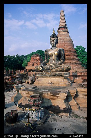 Classic sitting Buddha image and tiered, bell-shaped chedi. Sukothai, Thailand (color)