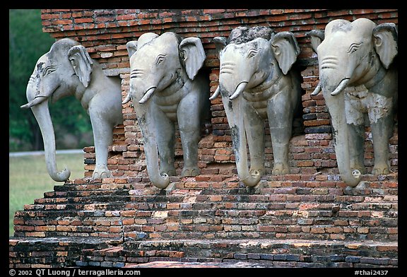 Some of the 36 elephants at the base of Wat Cahang Lom. Sukothai, Thailand (color)