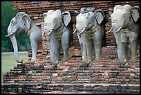 Some of the 36 elephants at the base of Wat Cahang Lom. Sukothai, Thailand (color)