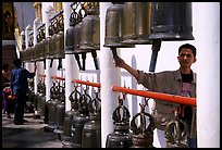 Worshiper rings bells at Wat Phra That Doi Suthep. Chiang Mai, Thailand (color)